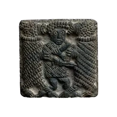 Pre-Viking Vendel period plate Torslunda type. Man between two bears. Main view of the sculpture