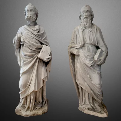 Gothic sculptures of the apostles Peter and Paul. Limestone statues. Main view of the sculpture